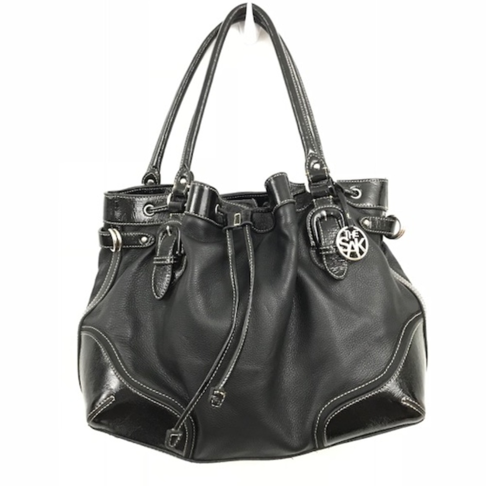 The Sak black pebbled + patent leather handbag